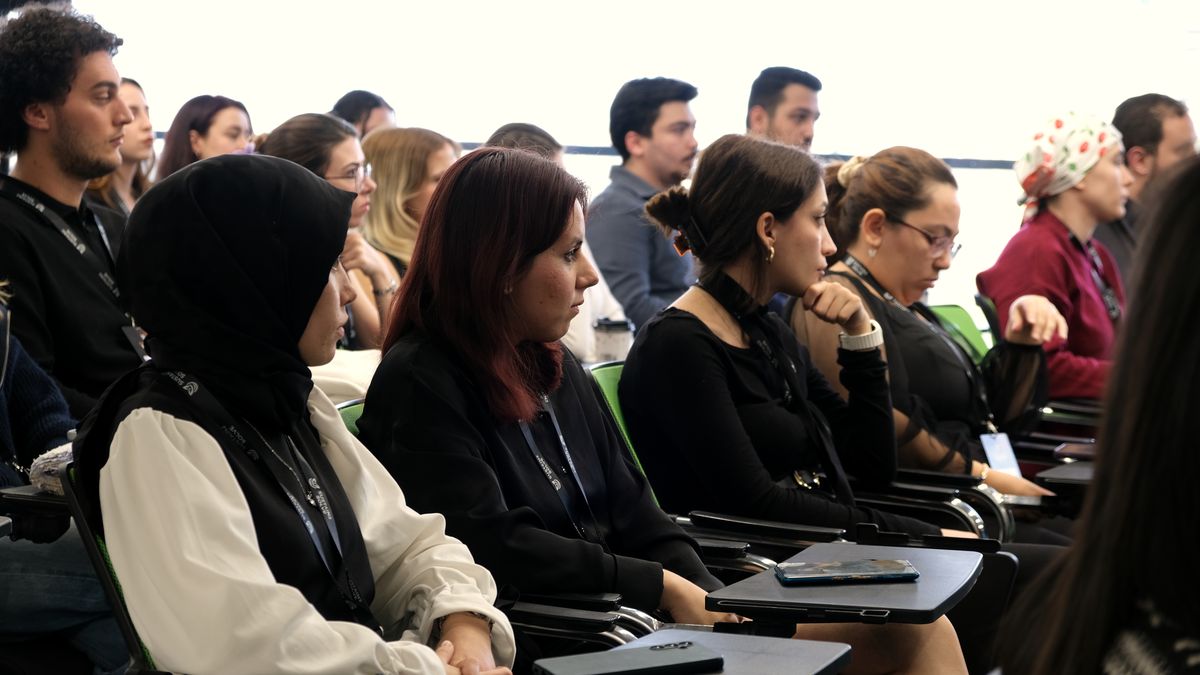 Genç katılımcılar oturumda dikkatle dinliyor, pencere ışığı